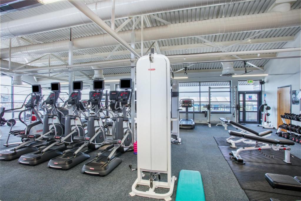 a gym with treadmills and cardio machines at Crowne Plaza Liverpool City Centre, an IHG Hotel in Liverpool