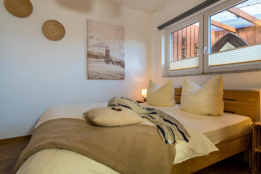 Postel nebo postele na pokoji v ubytování Ein Bett im Norden