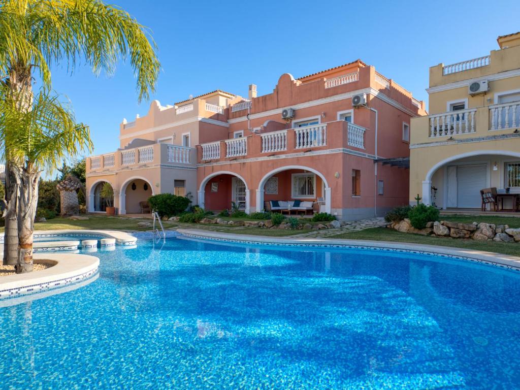 a large swimming pool in front of a building at Holiday Home Campoverde by Interhome in Denia