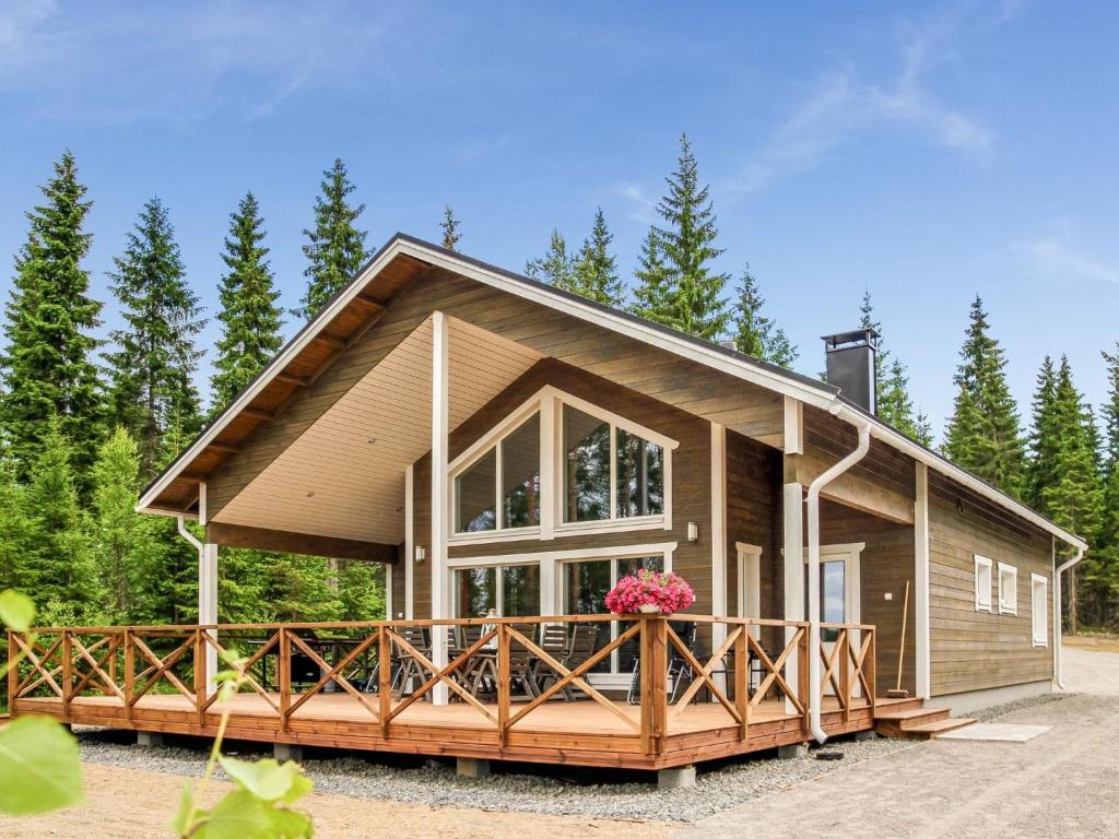 a large wooden house with a large window at Holiday Home Kielo by Interhome in Pertunmaa