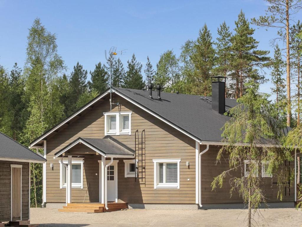 a house with a gambrel roof at Holiday Home Kurki by Interhome in Pertunmaa