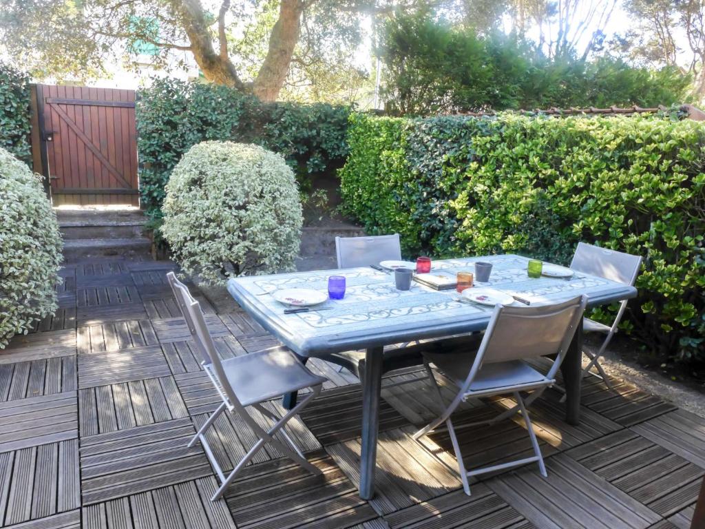 a blue table and chairs on a patio at Holiday Home lotissement Les Rives de Capbreton by Interhome in Capbreton