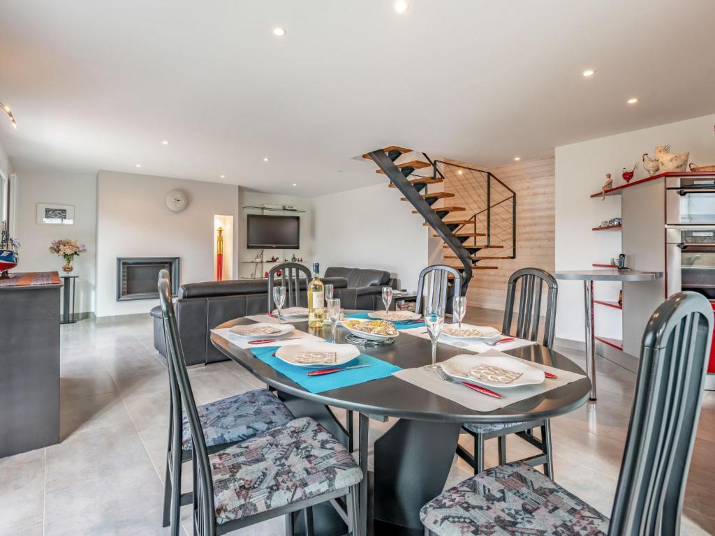 a dining room and living room with a table and chairs at Holiday Home Maison Du Port De Pêche by Interhome in Quiberon