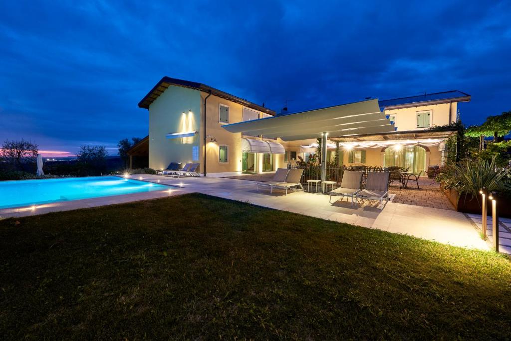 a villa with a swimming pool at night at Agriturismo Canova in Negrar