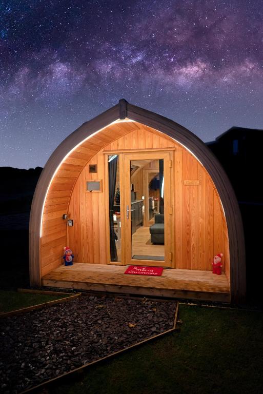 a wooden igloo house with a starry sky at North Coast 500 Pods in Achmelvich