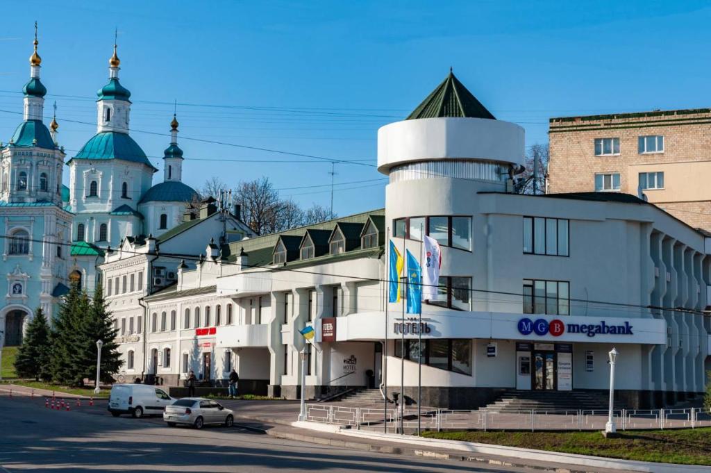 a large building with a large clock tower on top of it at Hotel Voskresensky in Sumy