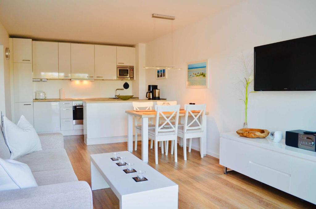 a living room with a couch and a table at Buhne 10 App Nr 26 max 2 Pers in Dierhagen