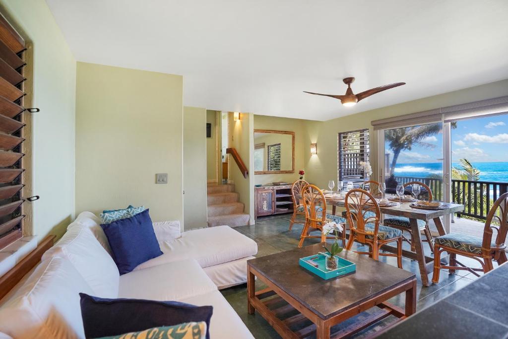 a living room with a white couch and a table at Kepuhi Hale TVNC #5156 in Hanalei