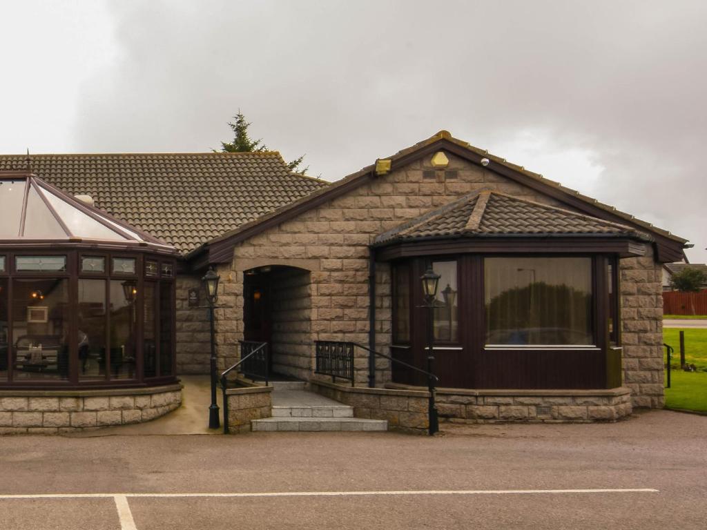 a stone house with a large window at Findlay's in Fraserburgh