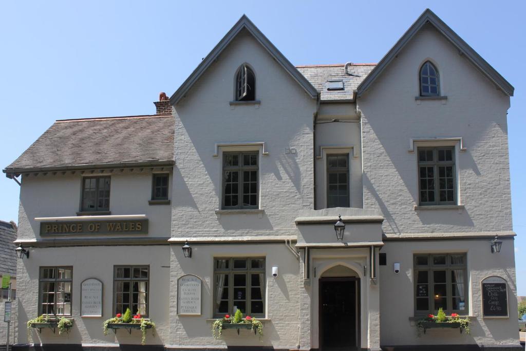 a white building with flowers in the windows at Prince of Wales in East Cowes