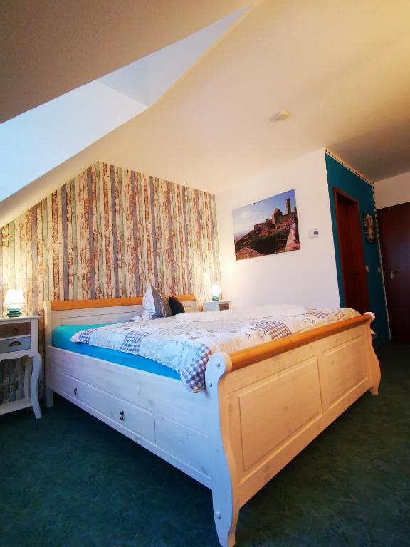 a bedroom with a large bed in a room at Casa Mia Pension am Mailandsberg - Klima in Lutherstadt Wittenberg