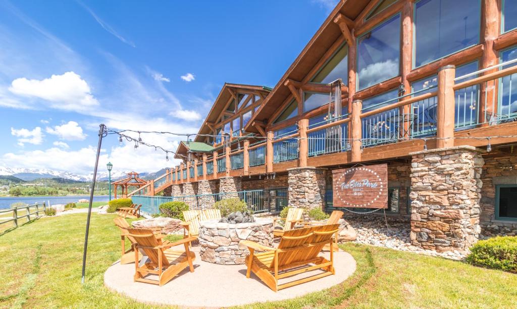 a house with rocking chairs in front of it at The Estes Park Resort in Estes Park