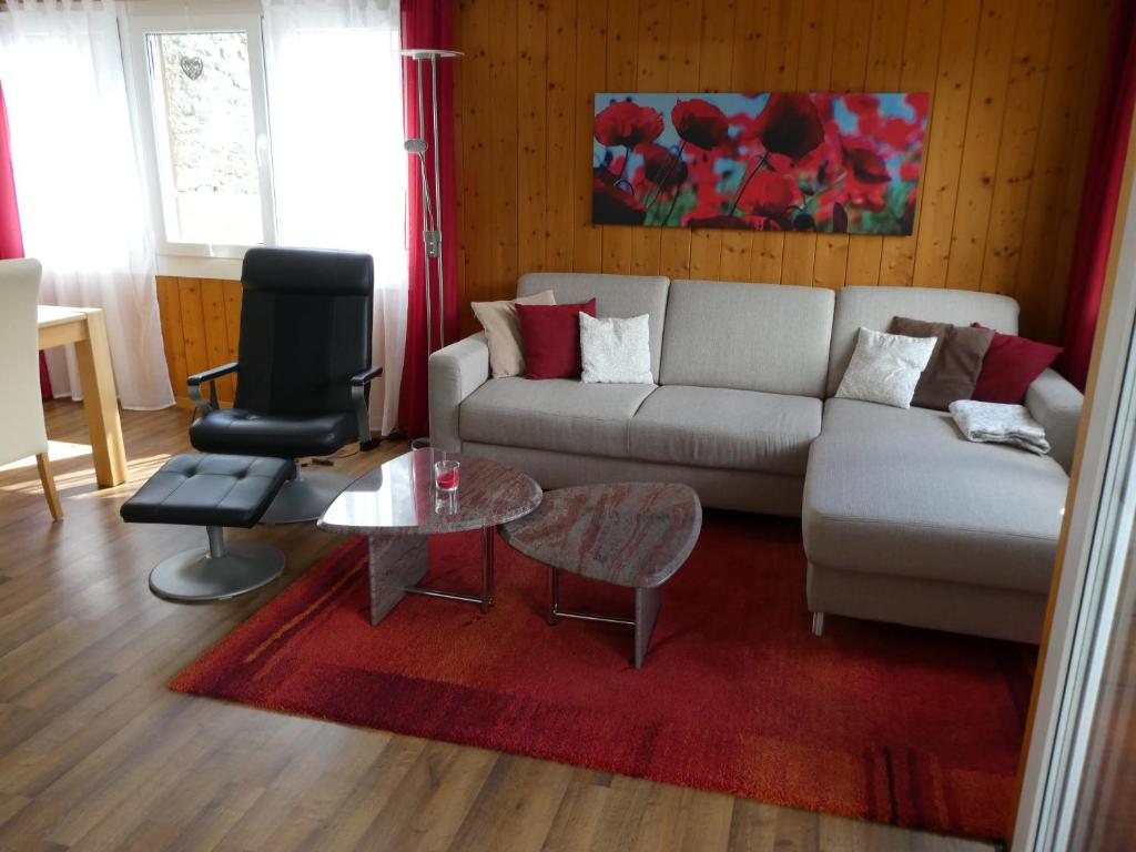 a living room with a couch and a table at Chalet Gerbera in Wengen