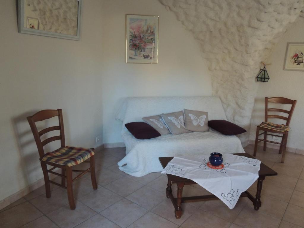 加普的住宿－Les grands bois，一间卧室配有一张床和两把椅子