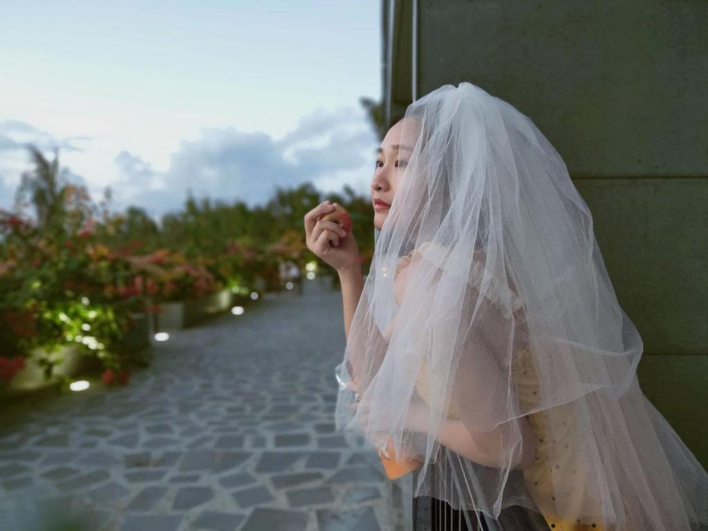 a little girl wearing a wedding veil at Saipan Skyline Designers Hotel in Saipan
