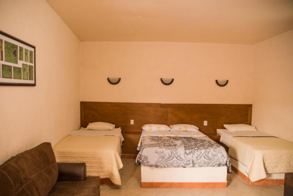 Postel nebo postele na pokoji v ubytování Hotel Cuauhtemoc