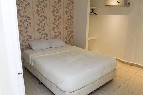 Postel nebo postele na pokoji v ubytování Hostal Familiar Carmencita