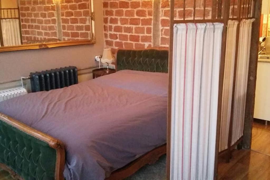 - une chambre avec un lit vert dans l'établissement Charming old style, à Honfleur