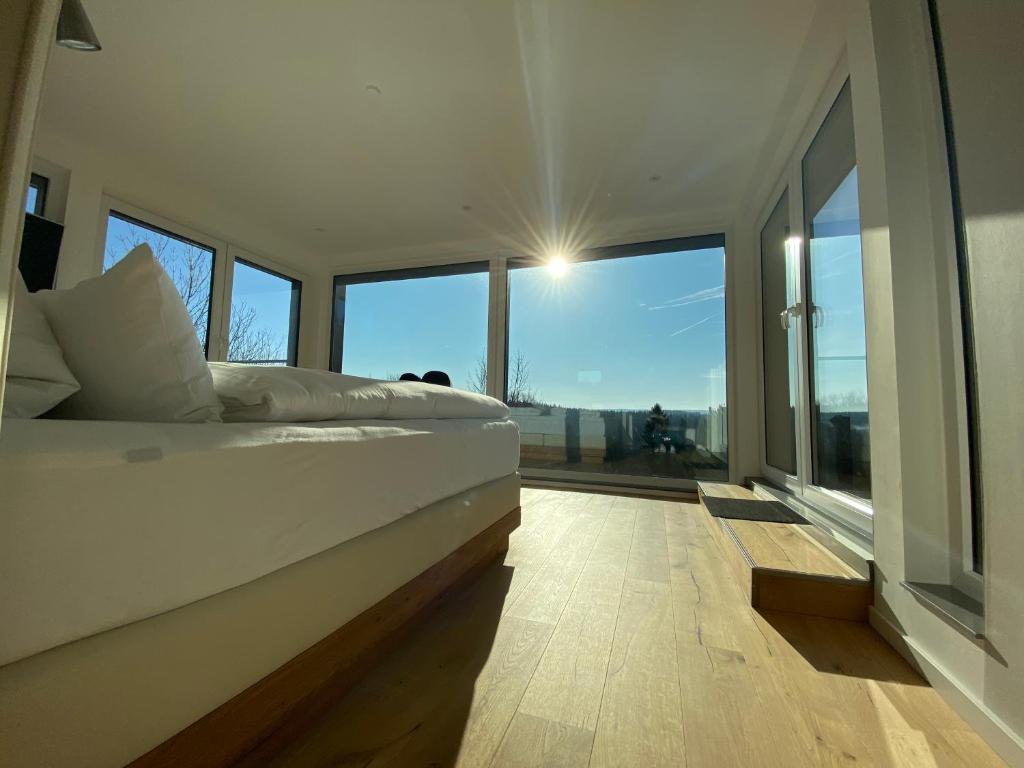 a bedroom with a bed and a large window at Braunlage Lodge in Braunlage