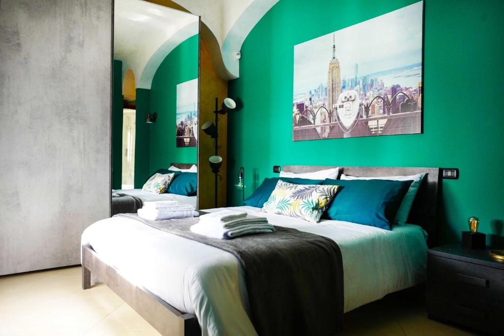 a bedroom with green walls and a large bed at B&B da Titina 153 in Castel San Giorgio
