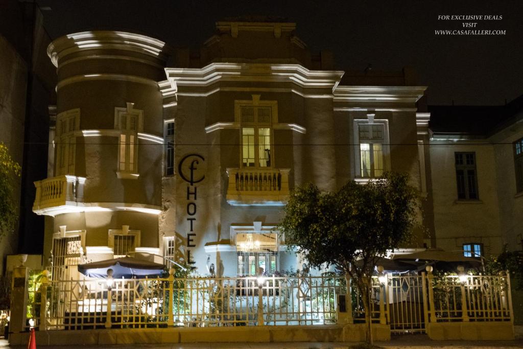 a building with a sign on the front of it at night at Casa Falleri Boutique Hotel in Lima