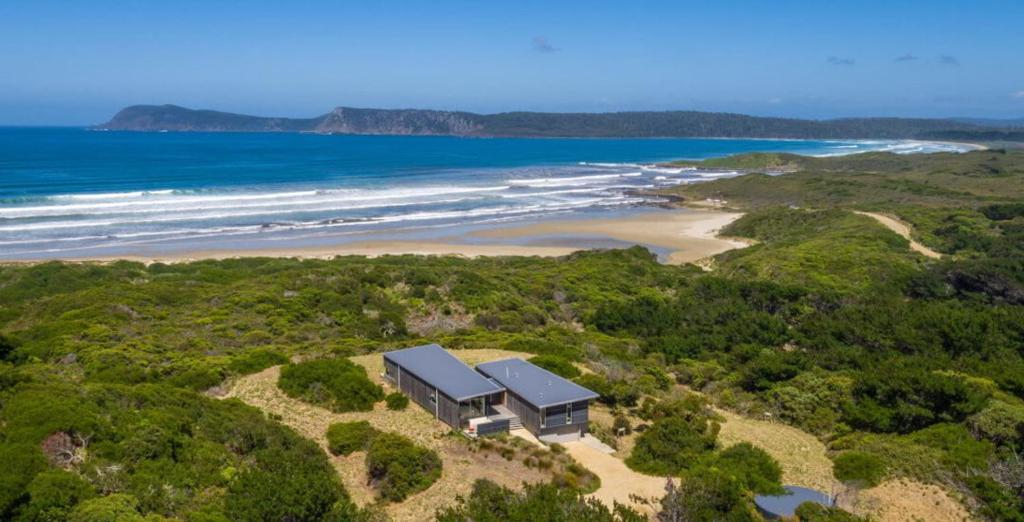 an aerial view of a house on a beach at Cloudy Bay Beach House in South Bruny