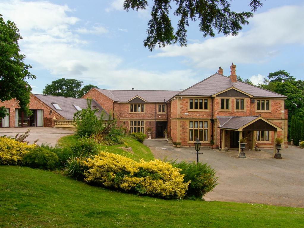 a large brick house with a driveway in front of it at Richmond Hall in St Asaph