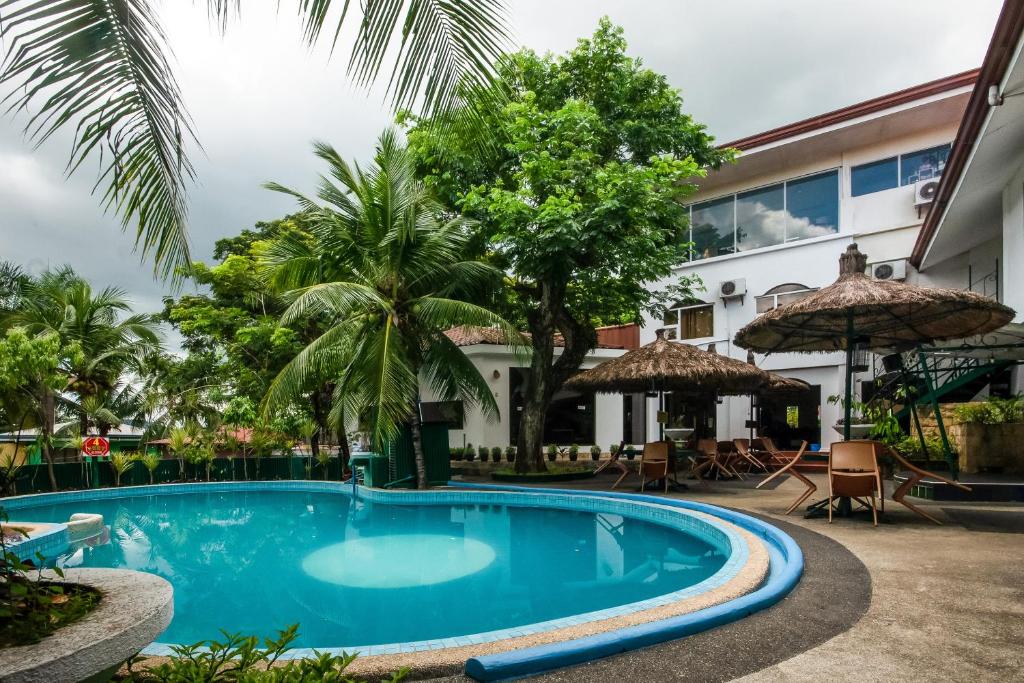 a swimming pool in front of a building at Cebu Hilltop Hotel in Cebu City