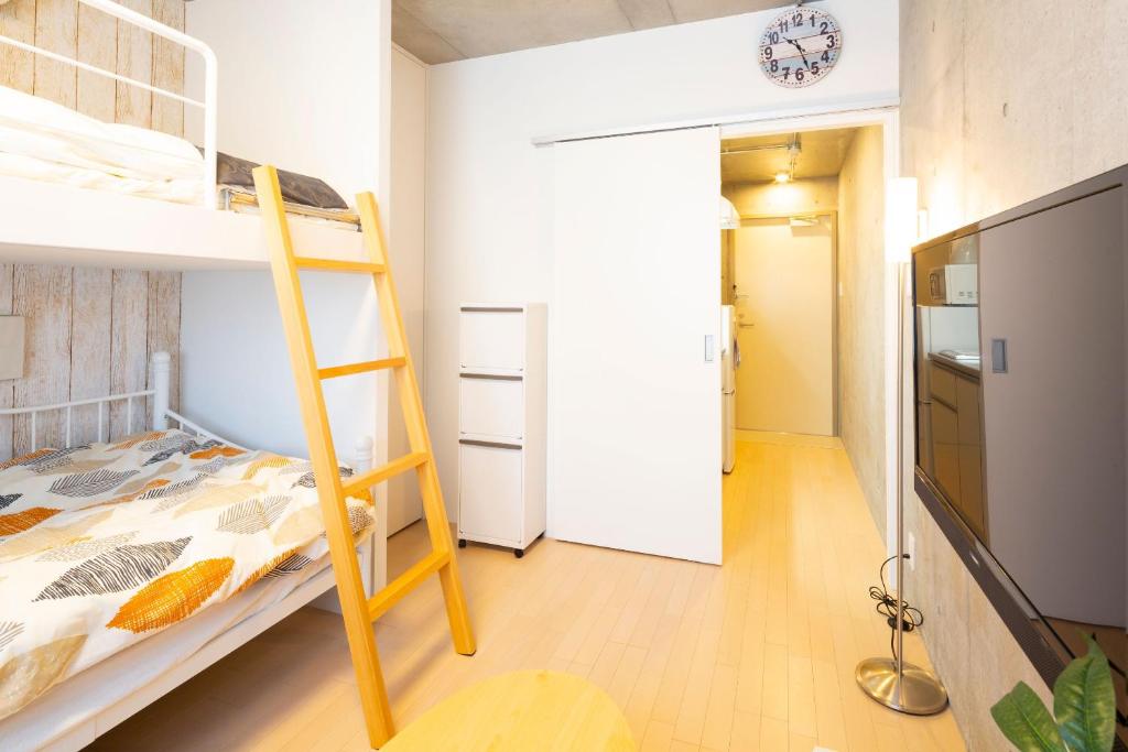 Postel nebo postele na pokoji v ubytování Laffitte Hirai Condominium Hotel