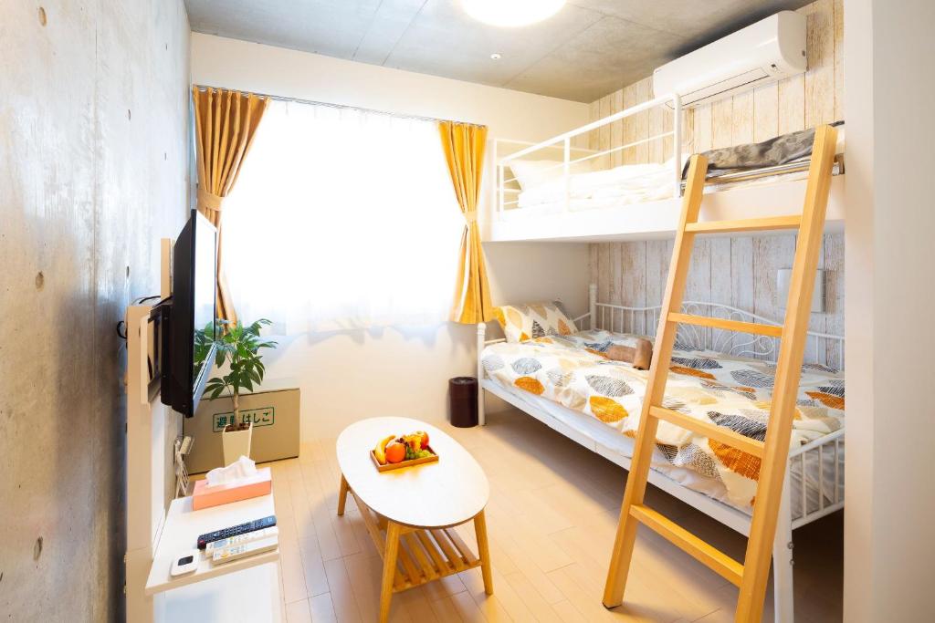 Postel nebo postele na pokoji v ubytování Laffitte Hirai Condominium Hotel