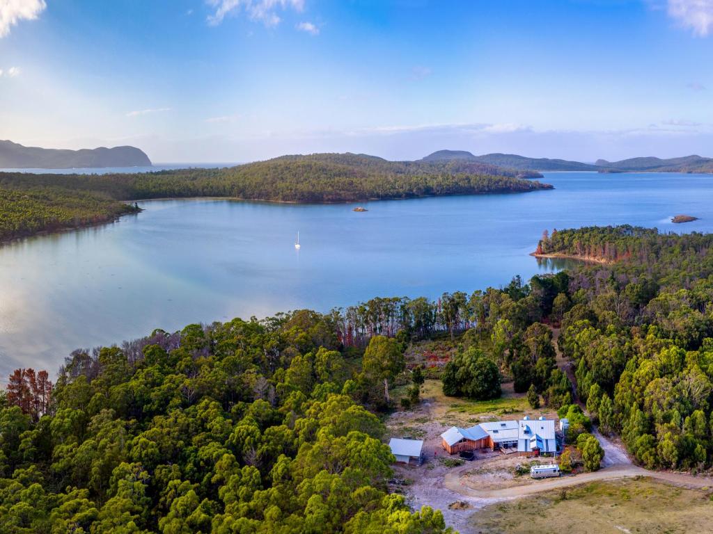 an aerial view of a lake with a house at Bruny Island Lodge in South Bruny