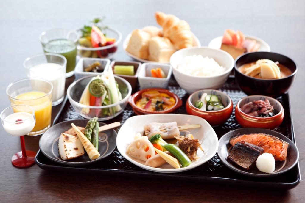 a tray filled with different types of food on a table at Takayama Ouan in Takayama
