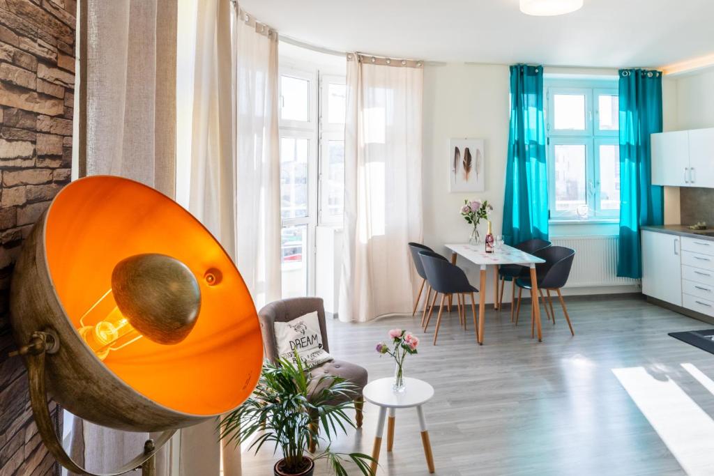 a living room with a kitchen and a dining room at APARTIA Skořepka 15, Brno-center in Brno