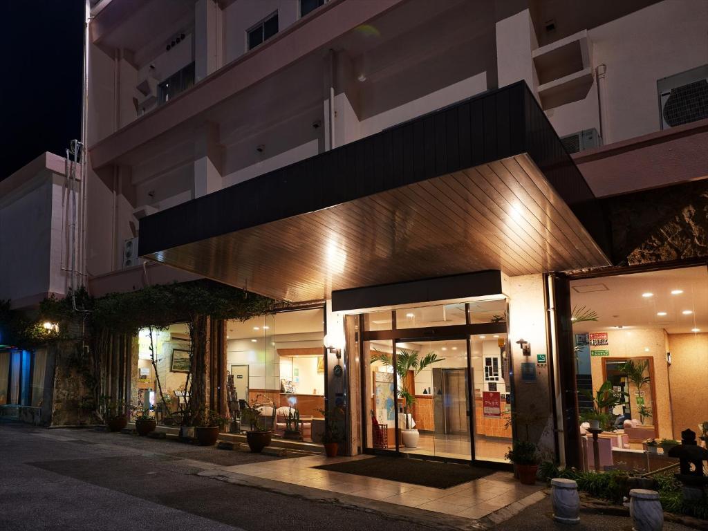 a building with a store front at night at Crown Hotel Okinawa in Okinawa City