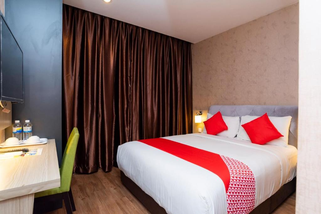 Postel nebo postele na pokoji v ubytování Hotel 101 Ulu Tiram