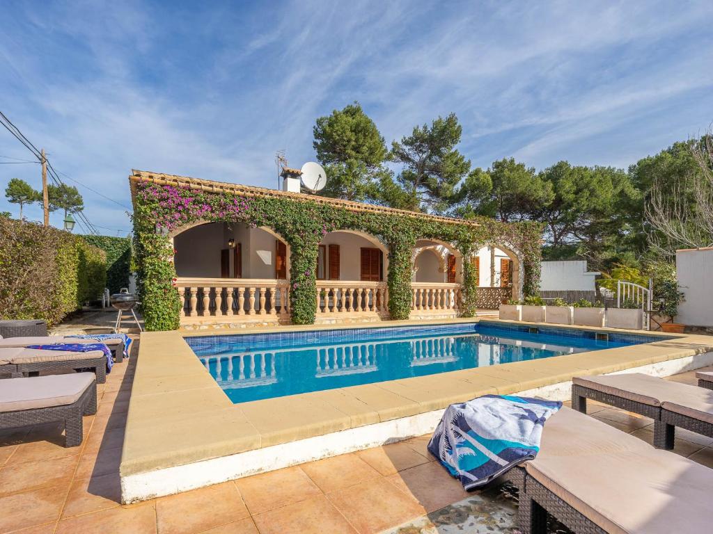 a villa with a swimming pool and a house at Villa Can Odile By SunVillas Mallorca in Cala de Sant Vicent