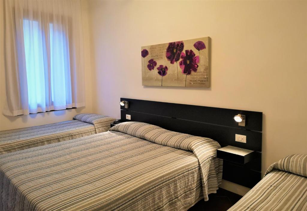 Postel nebo postele na pokoji v ubytování Hotel Rossi