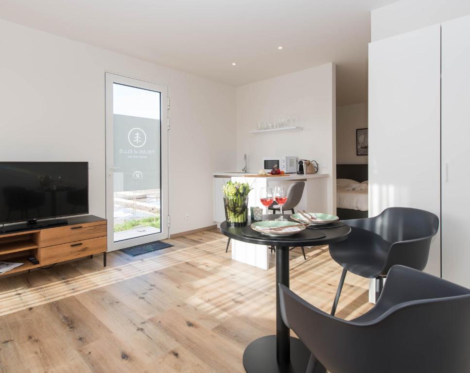 a living room with a table and a television at Fields of Ellis in Middelkerke