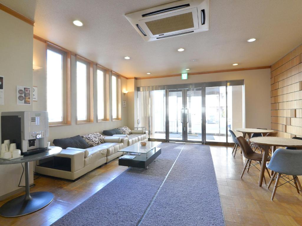 a living room with a couch and a table at Hotel S-PAL in Hakodate