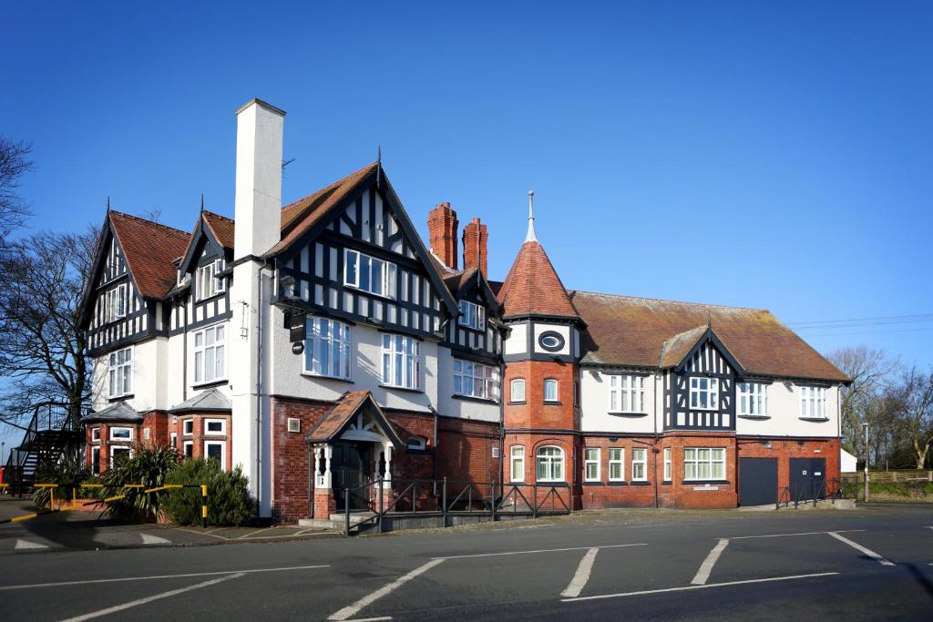 an old building on the corner of a street at Miller & Carter Aughton by Innkeeper's Collection in Ormskirk