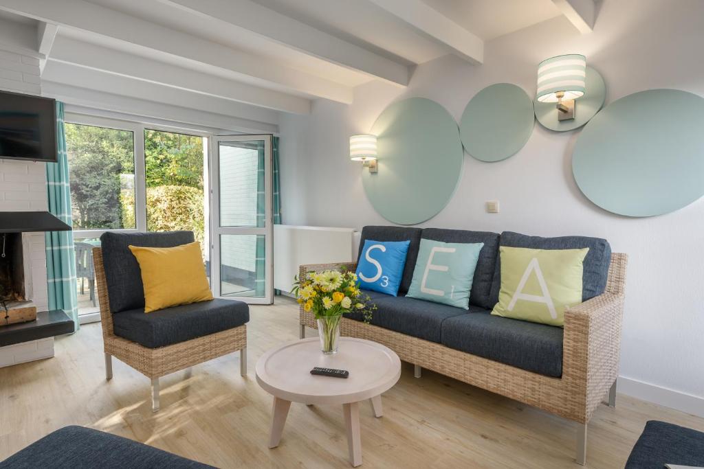 a living room with a couch and chairs and a table at Center Parcs Park De Haan in De Haan