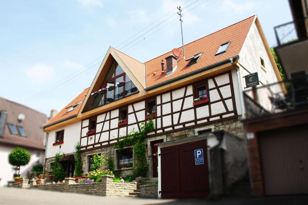 a large building with a brown roof at Brunnenhof Randersacker - das kleine Hotel in Randersacker