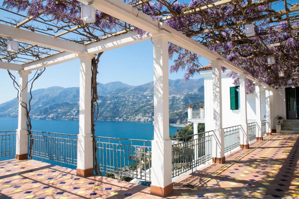 a pergola with a view of the water and mountains at Villa Scarlato in Maiori