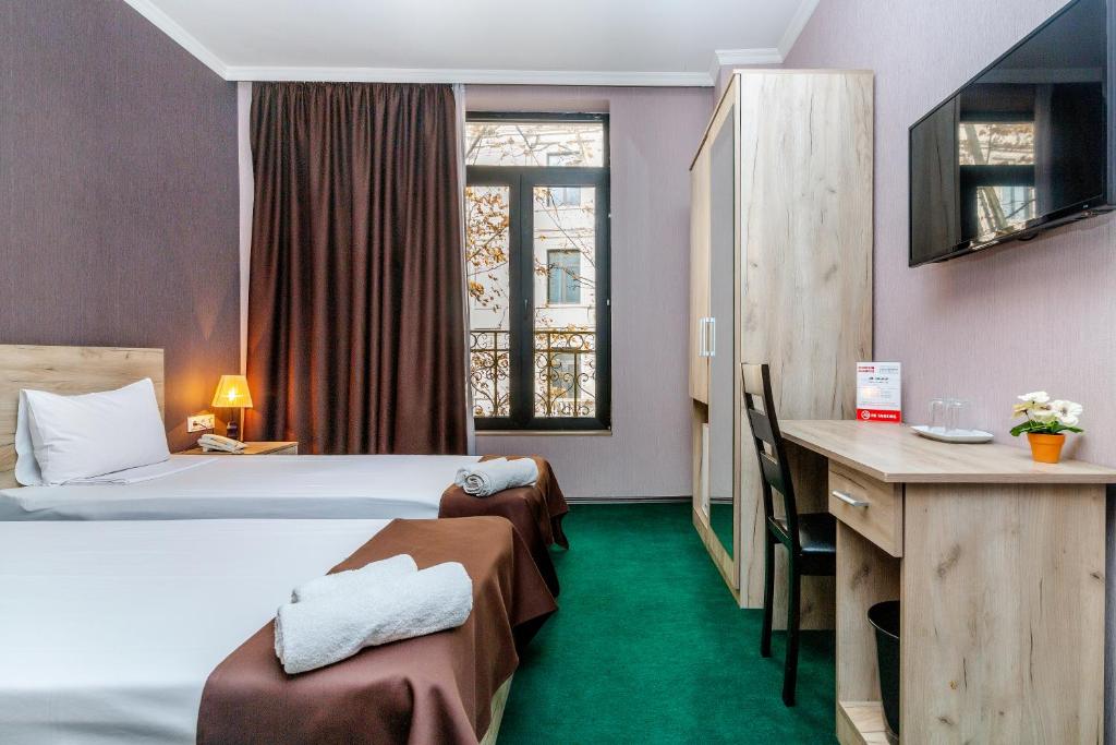 Postel nebo postele na pokoji v ubytování Hotel Marlyn
