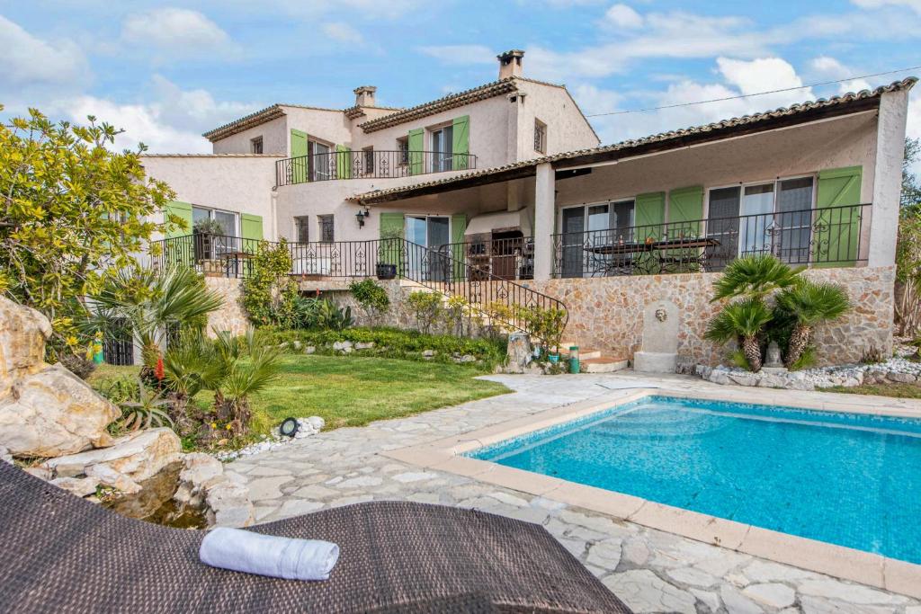 a villa with a swimming pool in front of a house at Villa Bellet in Nice