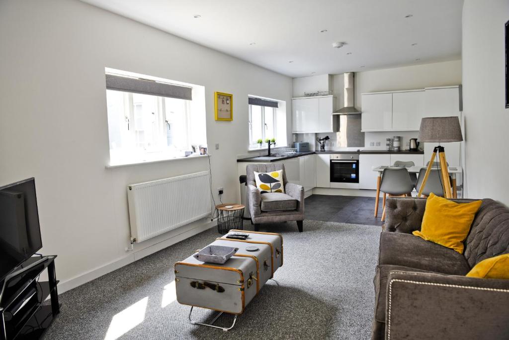 a living room with a couch and a table at Toothbrush Apartments - Central Ipswich - Fore St in Ipswich