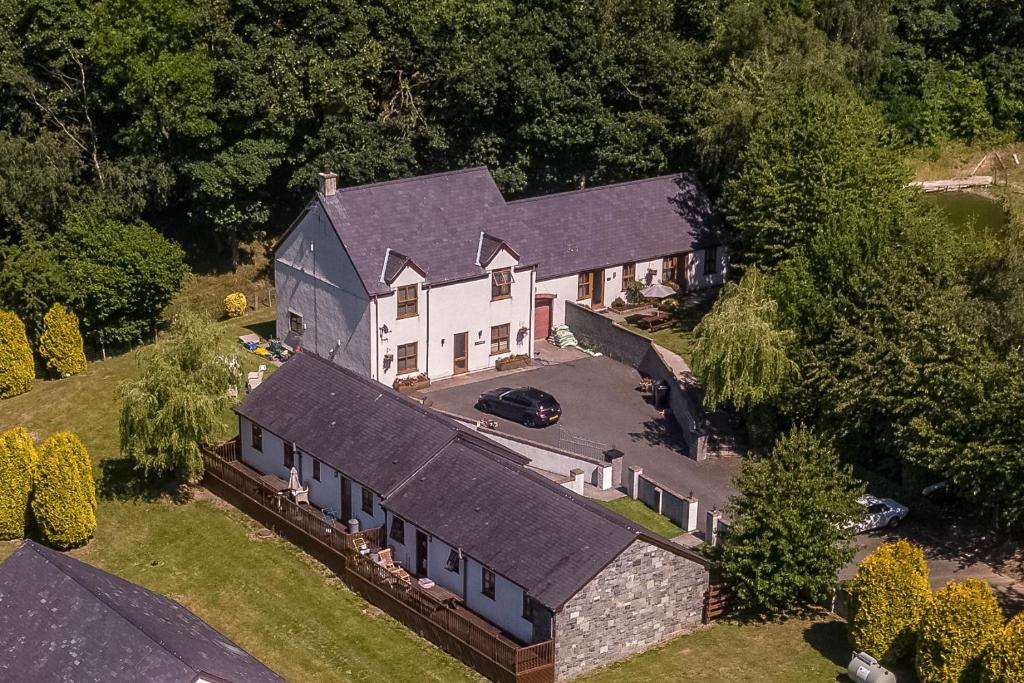 an aerial view of a house with a car parked in the driveway at Graiglwyd Springs Holiday Cottages in Conwy