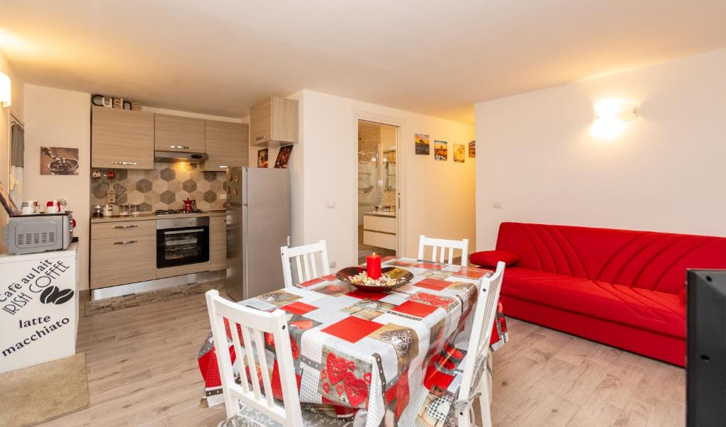 a living room with a table and a red couch at sweet home station in Rome