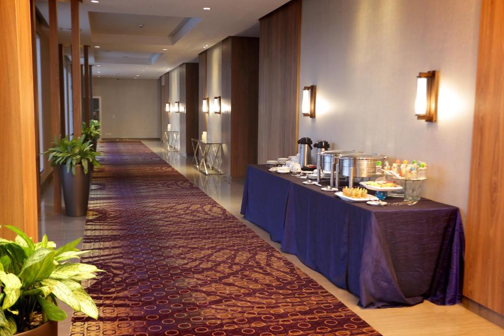 a long hallway with a table with food on it at Crowne Plaza Airport by IHG in Tocumen