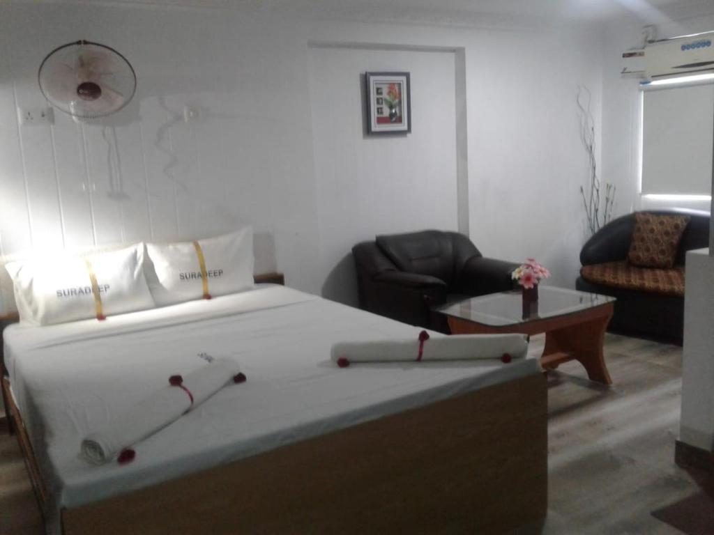 Un dormitorio con una cama, una silla y una mesa. en Twilight Bay resort By K Hotels, en Mahabalipuram